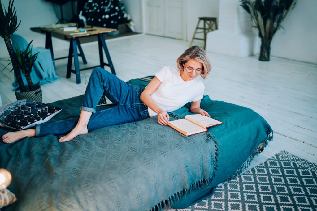 Caucasian female in casual apparel spending time for literature hobby