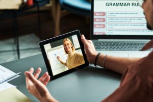 Confident blond tutor presenting new English grammar subject