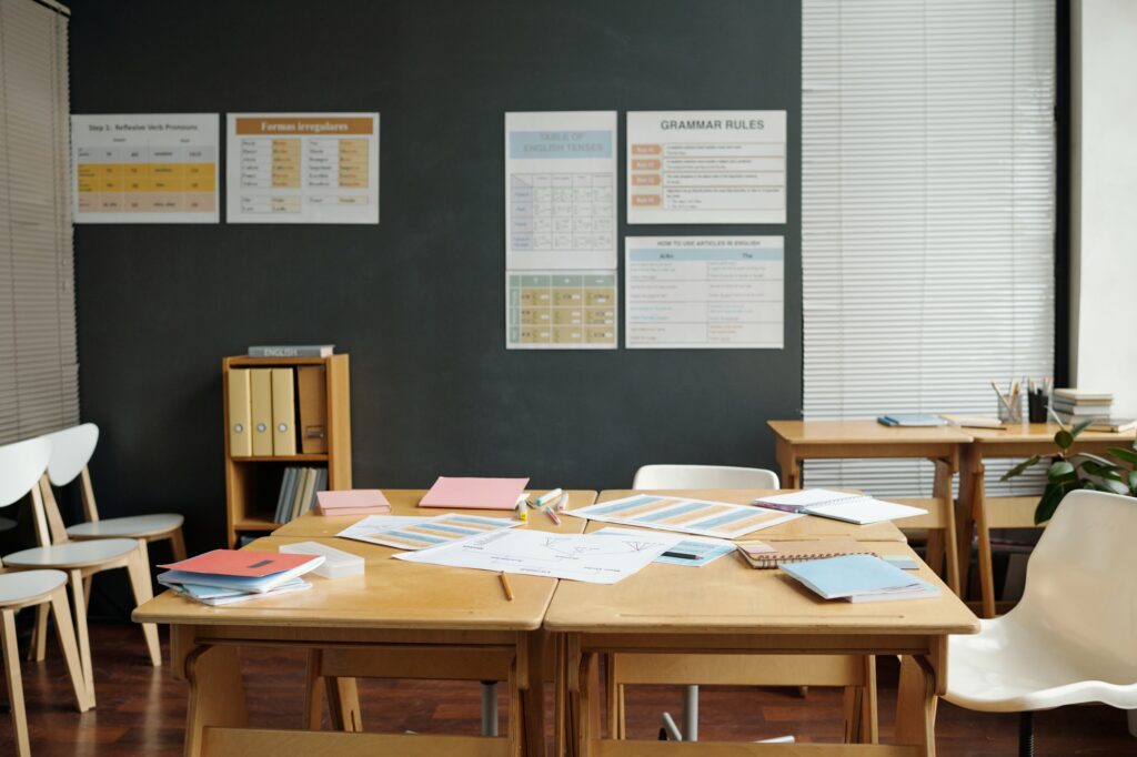 Nobody in spacious classroom of English language with documents and copybooks