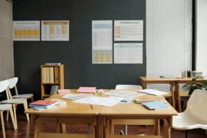 Nobody in spacious classroom of English language with documents and copybooks