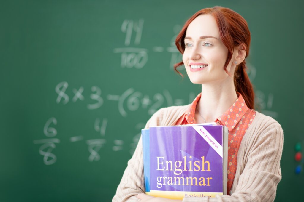 Red-haired English teacher feeling thoughtful before lesson