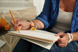 Student writing in textbook