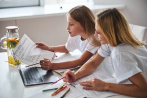 Teenager checking her test results with her parent